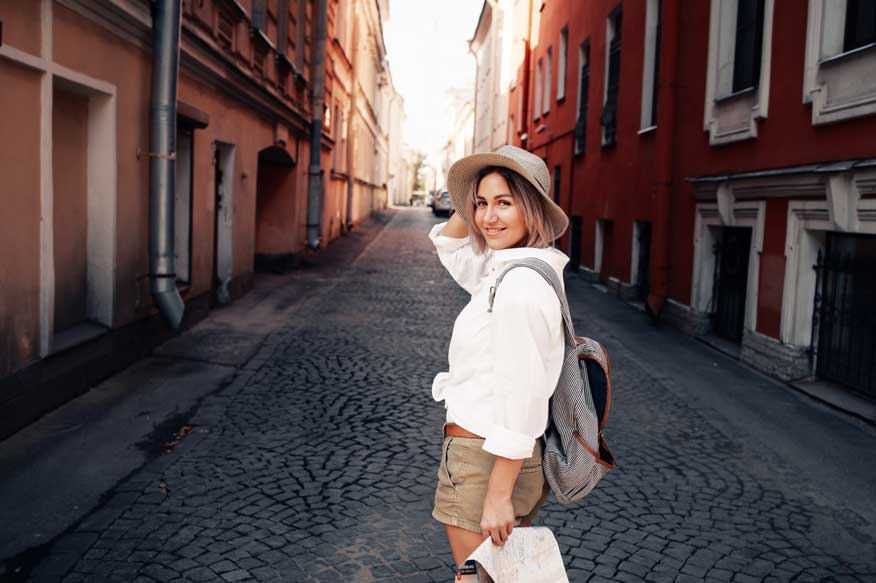 A traveller exploring a sunlit cobbled street